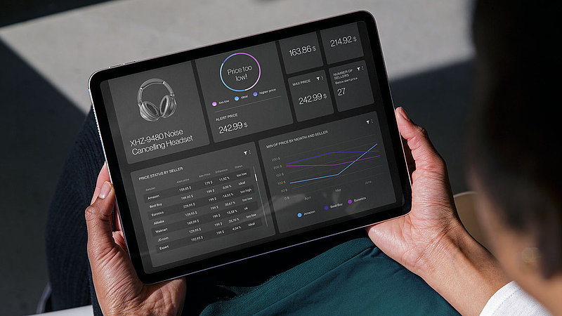 A woman holds a tablet with a dashboard of XPLN's GATEKEEPER software solution
